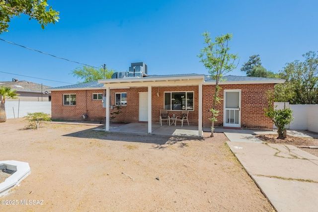 6517 E Cooper St, Tucson, AZ 85710 - back of property featuring a patio area and brick siding