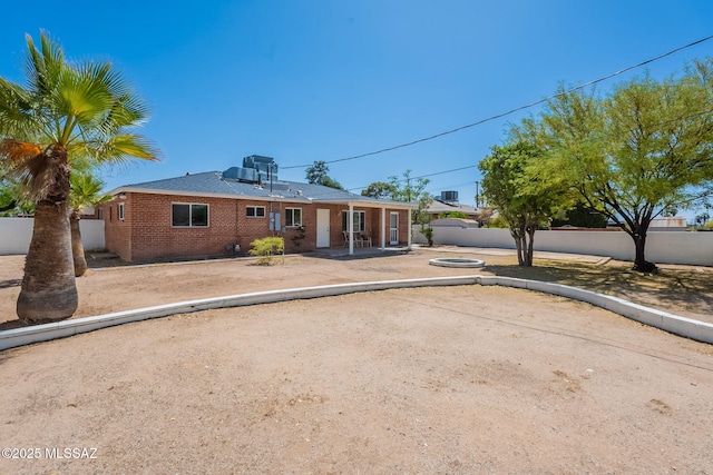 6517 E Cooper St, Tucson, AZ 85710 - view of front facade featuring brick siding and a patio area