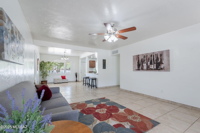 6517 E Cooper St, Tucson, AZ 85710 - living area with a chandelier, a ceiling fan, light tile patterned flooring, and baseboards