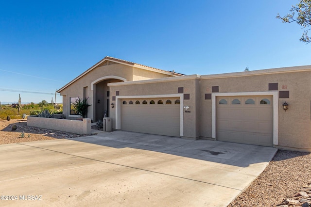 view of front of property featuring driveway, stucco siding, and an attached garage