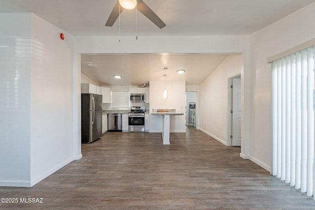 kitchen with dark wood finished floors, white cabinets, a ceiling fan, and appliances with stainless steel finishes