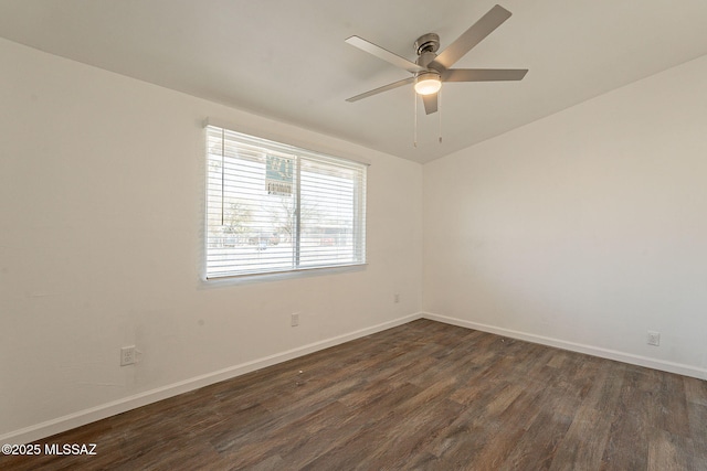 spare room with dark wood-style floors, baseboards, and ceiling fan