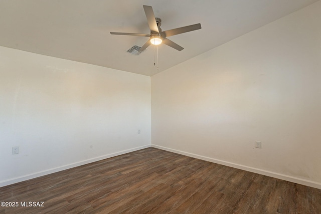 unfurnished room featuring dark wood-style floors, visible vents, ceiling fan, and baseboards