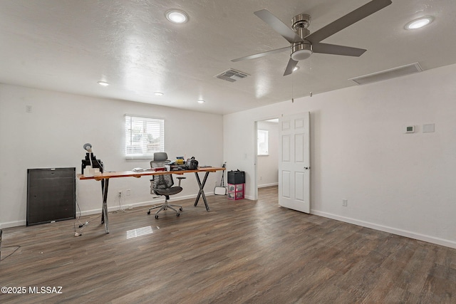 office area with a textured ceiling, visible vents, baseboards, wood finished floors, and a ceiling fan