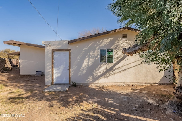 rear view of property with stucco siding