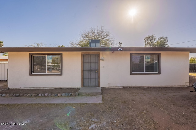 single story home featuring stucco siding