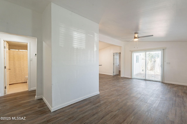 unfurnished room featuring baseboards, lofted ceiling, ceiling fan, and dark wood-type flooring