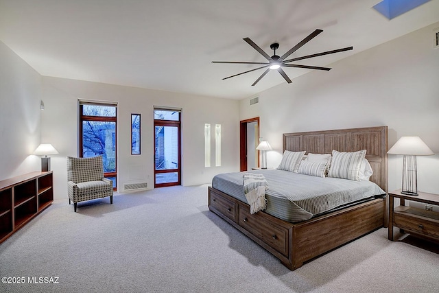 carpeted bedroom with visible vents, access to exterior, and ceiling fan