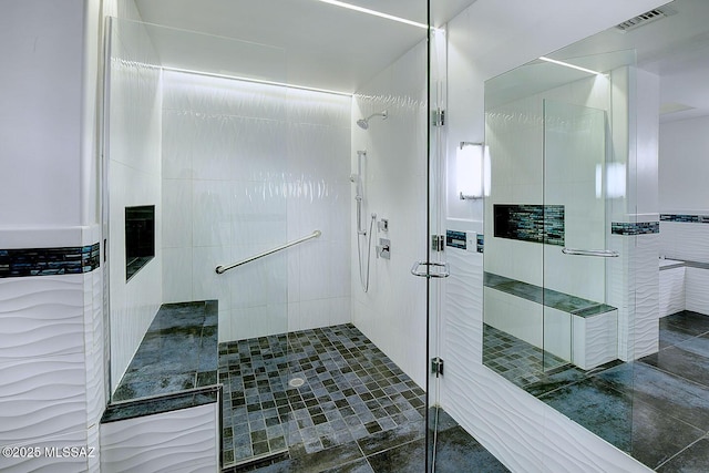 bathroom with visible vents and a stall shower