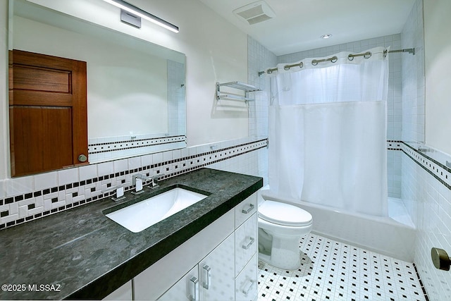 full bath featuring visible vents, toilet, shower / bath combination with curtain, tile walls, and vanity
