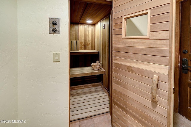 view of sauna / steam room featuring a textured wall and tile patterned floors
