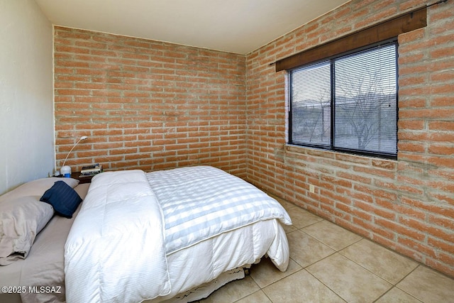 tiled bedroom with brick wall