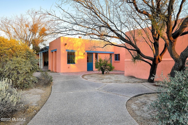 pueblo-style house with stucco siding