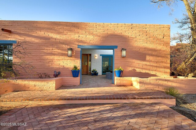 doorway to property with a patio