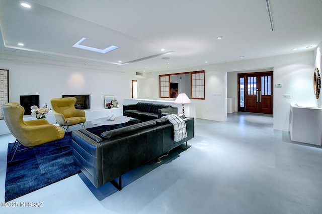 living room with recessed lighting and concrete flooring
