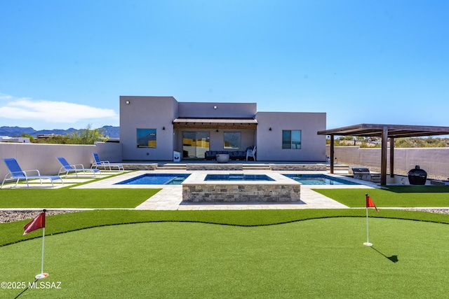 back of property featuring a patio, a fenced in pool, an in ground hot tub, and stucco siding