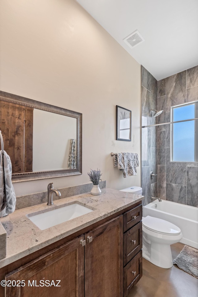 bathroom with bathing tub / shower combination, vanity, visible vents, and toilet