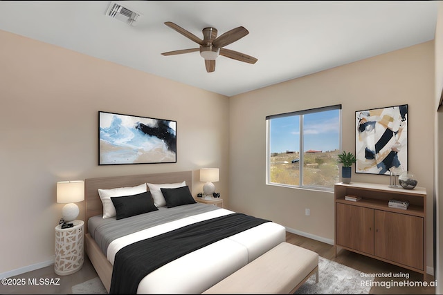 bedroom with wood finished floors, baseboards, and visible vents