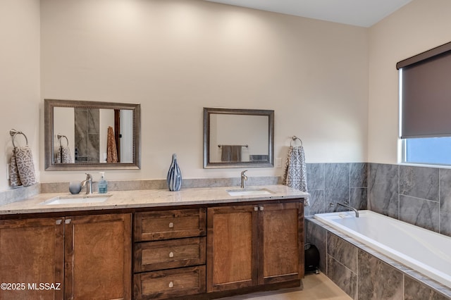 full bathroom featuring a sink, a bath, and double vanity