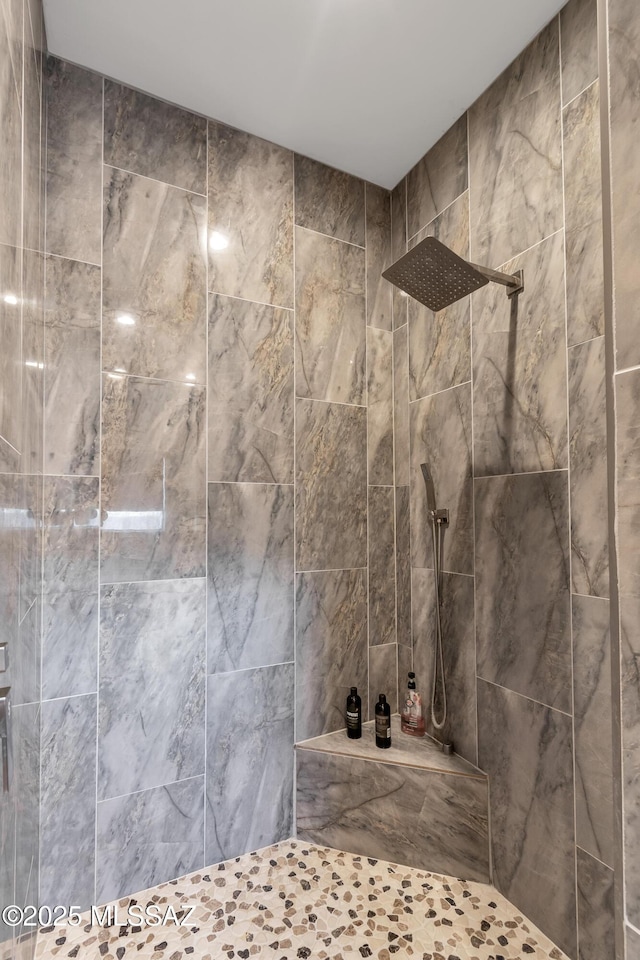 full bath with tiled shower