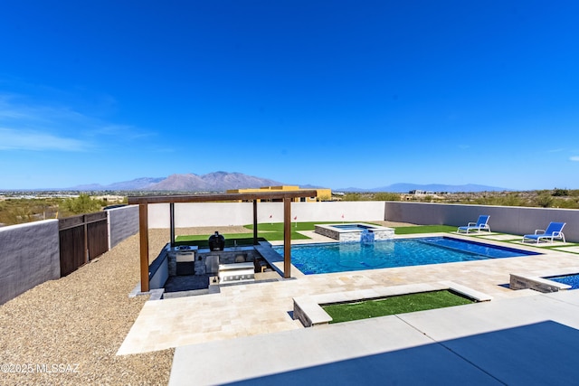 view of pool featuring a mountain view, a fenced backyard, a patio area, and a pool with connected hot tub
