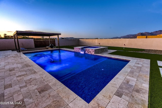 view of pool featuring a patio, a pool with connected hot tub, and a fenced backyard