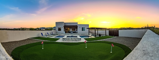 rear view of house featuring a fenced in pool, a patio, stucco siding, an in ground hot tub, and a fenced backyard