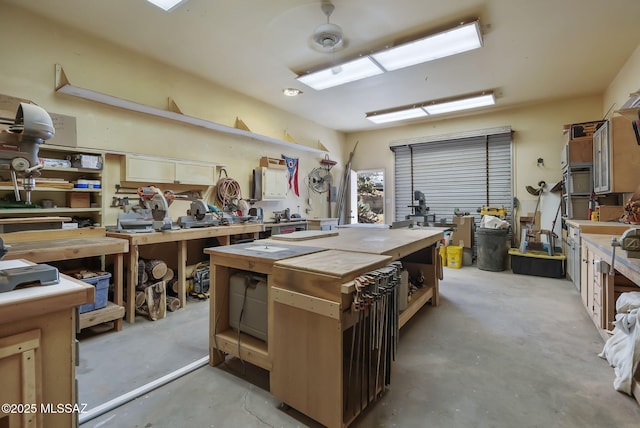 miscellaneous room with a workshop area and concrete floors