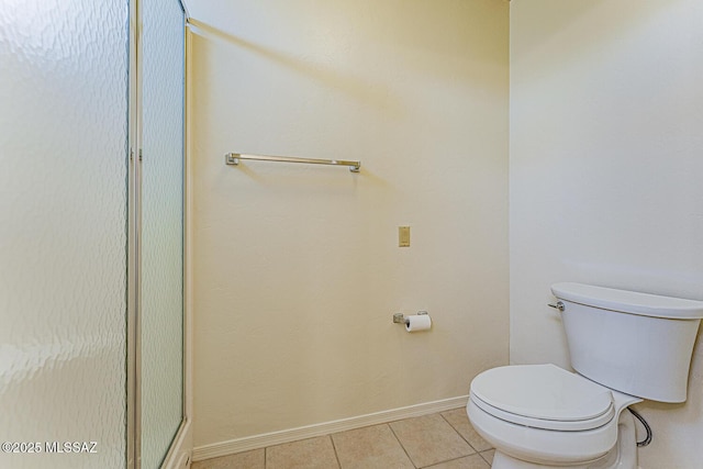 4661 S Desert Grove Ct, Green Valley, AZ 85622 - bathroom featuring a shower with shower door, toilet, baseboards, and tile patterned floors