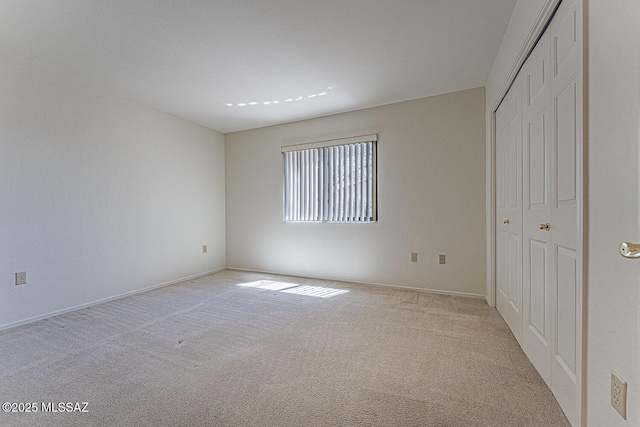4661 S Desert Grove Ct, Green Valley, AZ 85622 - unfurnished bedroom featuring baseboards, a closet, and light colored carpet