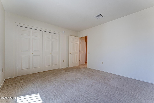 4661 S Desert Grove Ct, Green Valley, AZ 85622 - unfurnished bedroom with carpet floors, a closet, visible vents, and baseboards