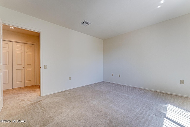 4661 S Desert Grove Ct, Green Valley, AZ 85622 - spare room featuring light carpet, visible vents, and baseboards