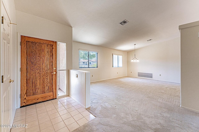 4661 S Desert Grove Ct, Green Valley, AZ 85622 - entryway with baseboards, visible vents, an inviting chandelier, and light colored carpet