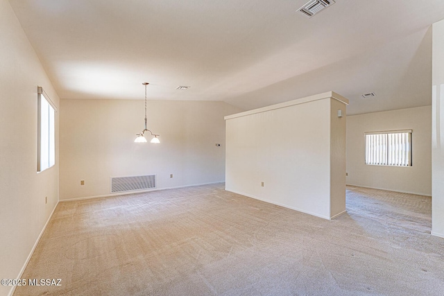 4661 S Desert Grove Ct, Green Valley, AZ 85622 - spare room featuring lofted ceiling, visible vents, and light colored carpet