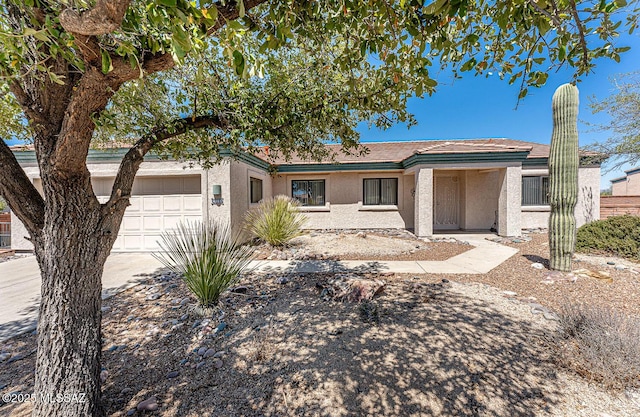 4661 S Desert Grove Ct, Green Valley, AZ 85622 - view of front of house with a garage, concrete driveway, and stucco siding