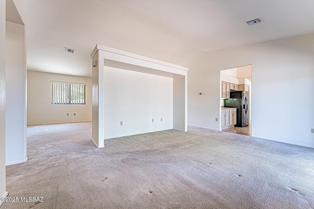 4661 S Desert Grove Ct, Green Valley, AZ 85622 - empty room with lofted ceiling, visible vents, and light colored carpet