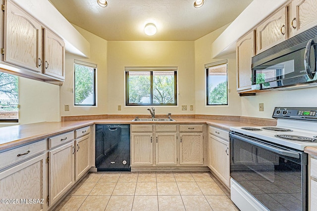 4661 S Desert Grove Ct, Green Valley, AZ 85622 - kitchen with black appliances, a sink, light countertops, and plenty of natural light