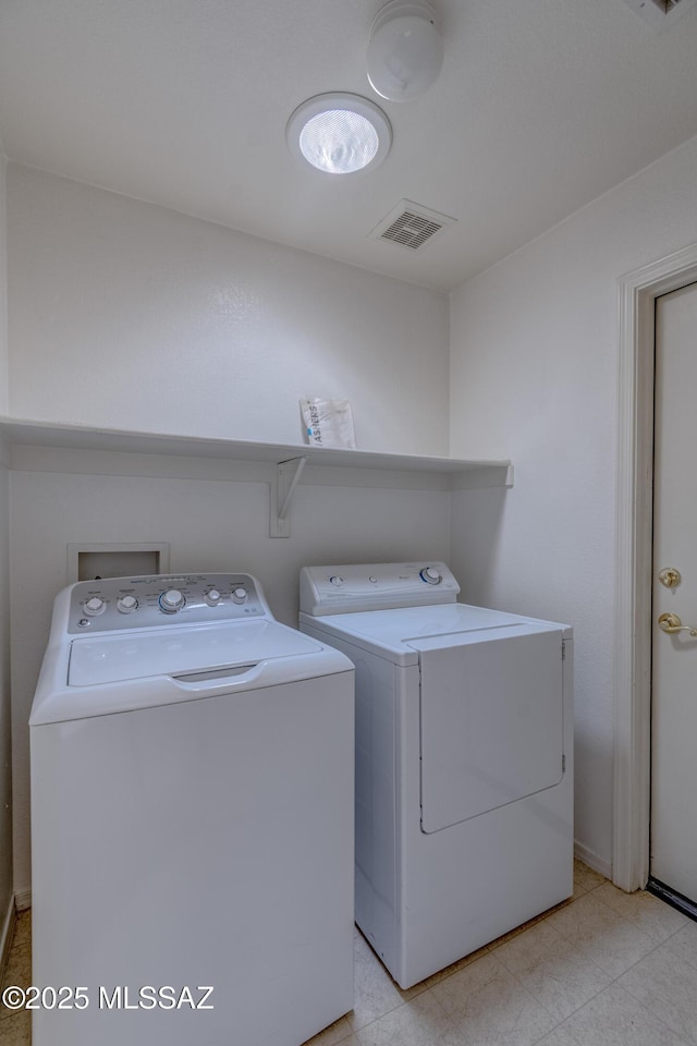 washroom with washer and dryer, laundry area, and visible vents