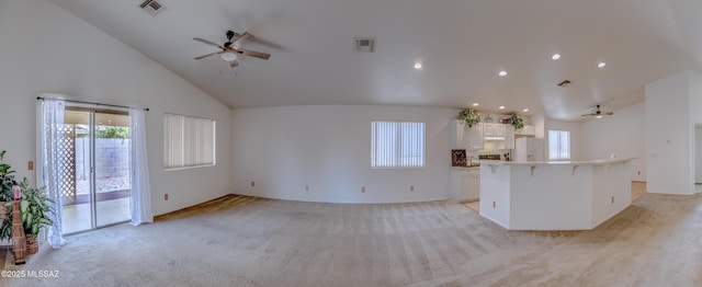 kitchen with light colored carpet, visible vents, white cabinets, white fridge with ice dispenser, and ceiling fan