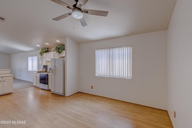 unfurnished living room featuring baseboards, ceiling fan, visible vents, and light wood-type flooring