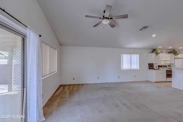 unfurnished living room featuring visible vents, ceiling fan, recessed lighting, light carpet, and vaulted ceiling