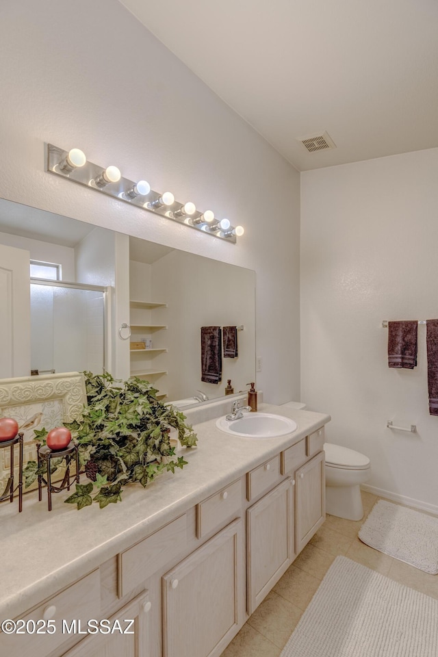 full bath with visible vents, toilet, vanity, a stall shower, and tile patterned flooring