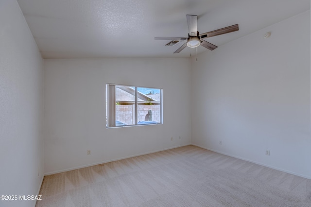 carpeted spare room with baseboards and ceiling fan