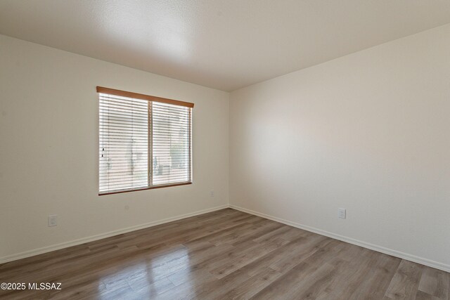 3856 W Argo St, Tucson, AZ 85742 - unfurnished room with wood finished floors and baseboards