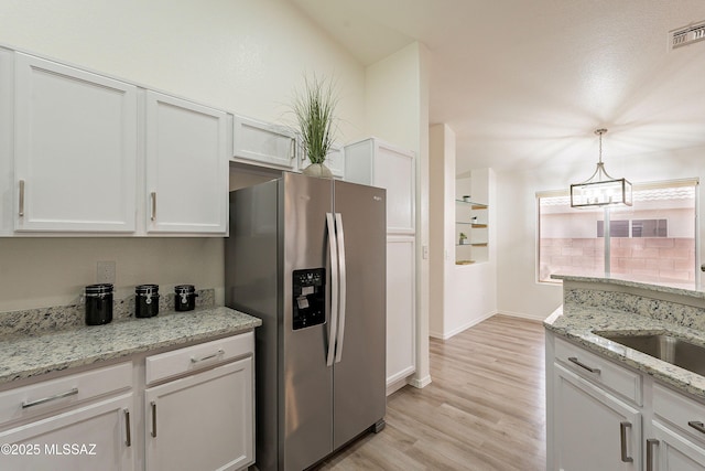 kitchen featuring white cabinetry, an inviting chandelier, stainless steel fridge with ice dispenser, light wood finished floors, and visible vents