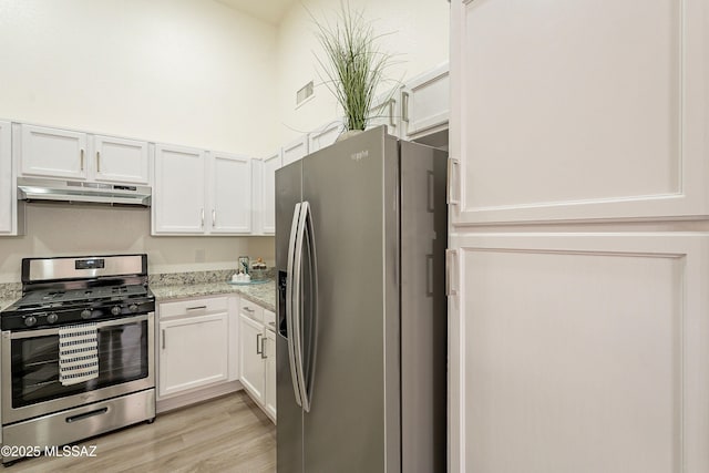 kitchen with white cabinets, light wood-style flooring, under cabinet range hood, and stainless steel appliances