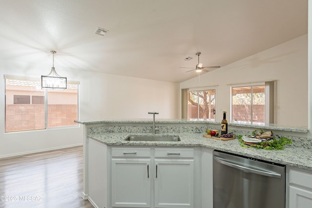 kitchen featuring vaulted ceiling, a sink, a ceiling fan, dishwasher, and visible vents