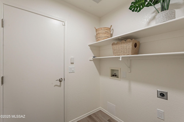 clothes washing area featuring hookup for an electric dryer, washer hookup, baseboards, laundry area, and wood finished floors