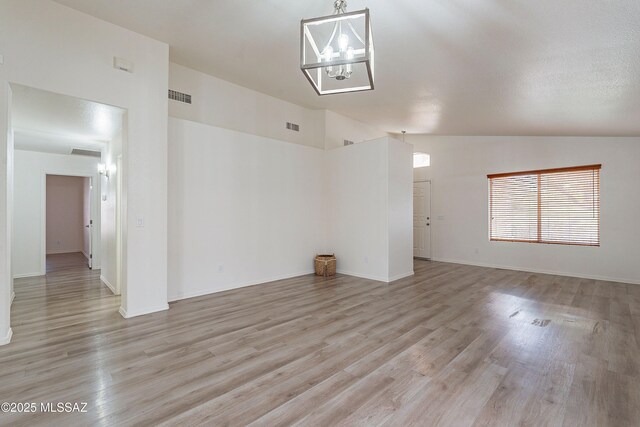 3856 W Argo St, Tucson, AZ 85742 - unfurnished room with light wood finished floors, a chandelier, baseboards, and high vaulted ceiling