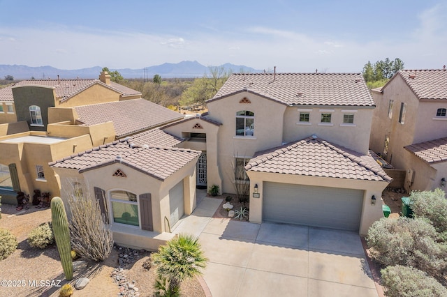 434 E Via Puente De La Lluvia, Sahuarita, AZ 85629 - mediterranean / spanish house featuring driveway, stucco siding, a mountain view, a tiled roof, and a garage